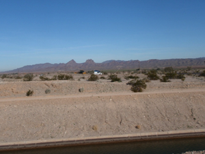 River, sand, car, mountains.