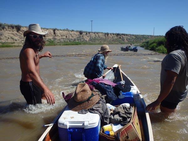 Canoeing through a barbwire fence on the Tongue River.