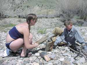 Splitting a log with stone and wood.