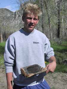 Student showing coal burned wood bowl.