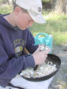 Student cutting mushrooms into stir fry.