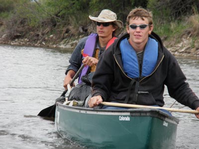 Two young men canoeing.