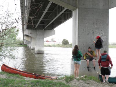 Waiting out the rain under a bridge.