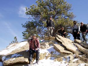 Campers climb rocks for picture.