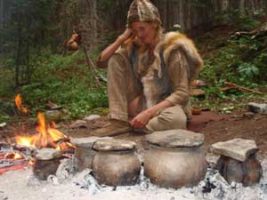Campfire cooking in clay pots.