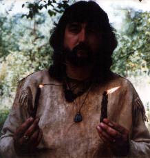 Man in Buckskins holding candles.