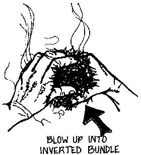 Blowing on ember in tinder nest.